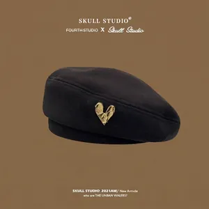 Retro black wool beret for women featuring a stylish gold heart buckle ornament