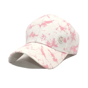 Detailed view of silver M logo and pink tie-dye pattern on cotton baseball cap