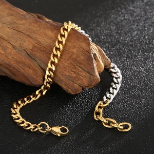 Detail of two-tone gold and silver Cuban link chain bracelet on weathered wood