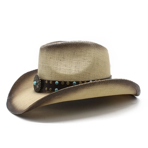 Detail of western straw hat with faux leather band and turquoise stone embellishments