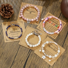Close-up of a 5-piece bead bracelet set with pink crystals and pearls on a gift card