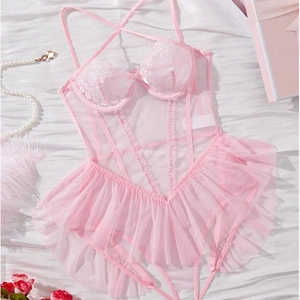 Detail of pink sheer bodysuit with white lace cups and bow on white silk backdrop