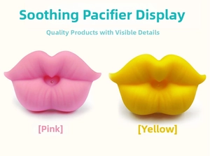 Detail of pink and yellow lip-shaped silicone pacifiers for babies on a white background