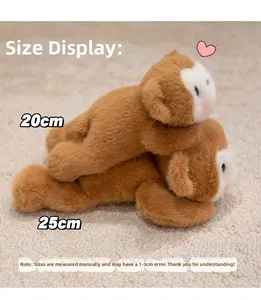 Detail view of brown and white monkey plush toys in 20cm and 25cm sizes on a soft rug