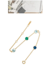 Macro detail of S925 sterling silver stamp on the gold plated gemstone chain bracelet
