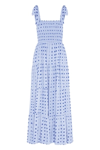 Detail of smocked bodice and adjustable tie straps on a blue tiered floral maxi dress