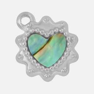 Macro view of heart-shaped pendant with beaded steel edge and iridescent abalone shell