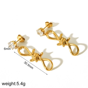 Detailed view of gold butterfly thorn earrings showing size and weight specifications