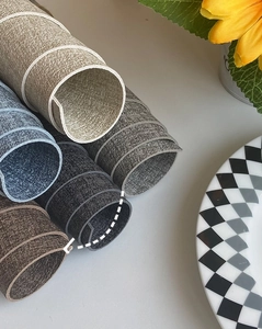 Close-up of 1.8mm thick waterproof leather placemats with a textured fabric finish