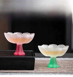 Detailed close-up of a lotus-shaped glass tea cup with frosted gradient finish