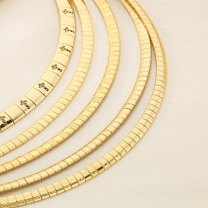 Close-up of five assorted gold-tone stainless steel snake and textured chain necklaces