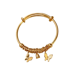 Adjustable gold plated butterfly bangle with bell charms on a clean white background