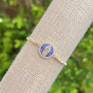 Detailed macro view of 18K gold plated Virgin Mary pendant with blue mosaic and zircon
