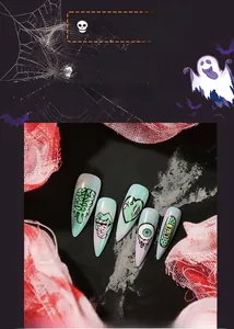 Detailed close-up of Halloween press-on nails with green gradient and eye patterns