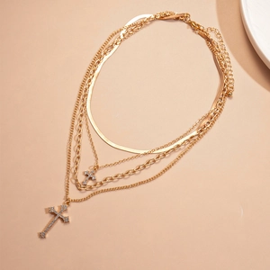Multilayer gold cross necklace with rhinestones and snake chain in a minimalist style