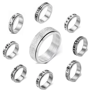Nine diverse silver spinning fidget rings made of titanium steel with moon and star patterns
