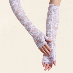 Close-up of white floral lace long fingerless gloves with delicate ruffled cuffs and texture