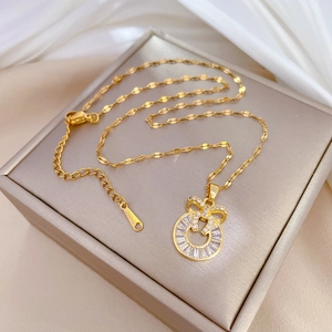 Luxurious gold stainless steel bow and ring pendant necklace with zircon on jewelry box