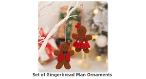 Close-up of gingerbread man plush pendants on Christmas tree branches with warm lighting