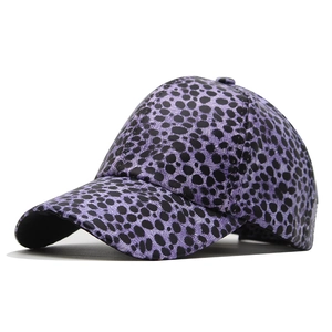 Detail of purple leopard print baseball cap with glossy finish and curved brim