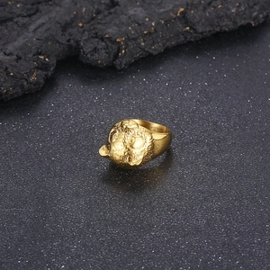 Macro shot of 316L gold panda ring showing fine metal texture and detailed carving