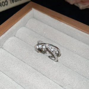 Macro view of silver star ring with zircon inlay and double-layer crossed band detail