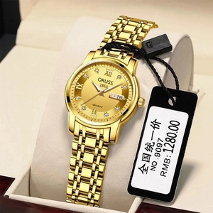 Detail of ORUSS gold quartz watch featuring a sunray dial and crystal hour markers