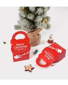 Close-up of red Christmas candy gift box with handle and reindeer snowflake patterns