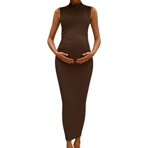 Close-up of side ruched texture on a sleeveless high-neck coffee maternity maxi dress