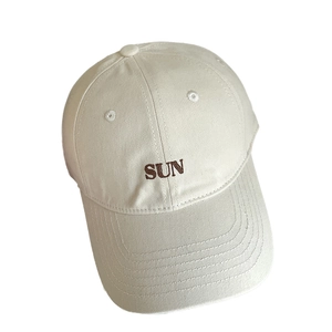 Minimalist off-white cotton baseball cap with sun embroidery and curved brim