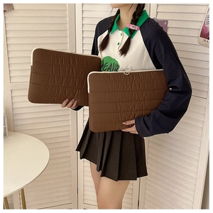 Quilted brown laptop sleeve with stripe stitching and padded protective material