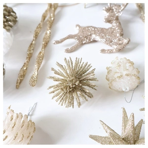 Detail of champagne gold and white glitter reindeer, pine cone, and star tree ornaments