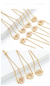 Detailed macro view of adjustable golden initial necklaces with micro-pave cubic zirconia
