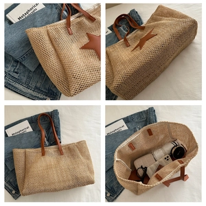 Detail view of woven straw tote bag with brown star patch and large storage capacity