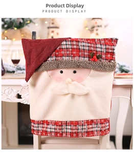 Detail of Santa Claus chair cover with red plaid fabric and festive holiday embroidery
