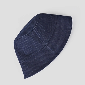 Detailed view of the dark blue corduroy fabric texture on a flat-laid bucket hat