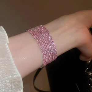 Macro shot of multi-layer pink rhinestone elastic bracelet with shimmering pavé setting