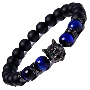 Close-up of wolf head charm with green zircon eyes on tiger eye and obsidian beads