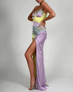 Detail of yellow and purple satin dress with blue lace trim and side slit texture