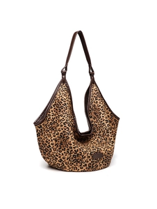 Front view of leopard print tote bag featuring dark brown leather trim and handles