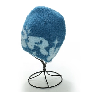 Detailed close-up of blue plush beanie showing soft faux mink fur and white star pattern