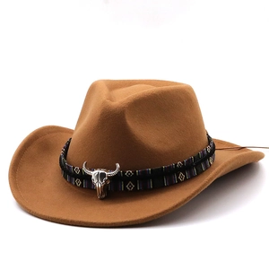 Detail of a brown felt cowboy hat featuring a tribal band and metal bull head buckle