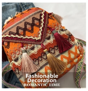 Close-up of ethnic woven backpack featuring colorful geometric patterns and silk tassels