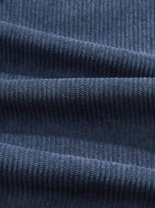 Detailed close-up of dark blue corduroy fabric showing soft vertical ribs and texture