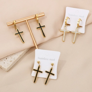 Cross earrings made of stainless steel in gold, black, and diamond-set styles on stands