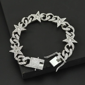 Macro shot of silver hip hop chain bracelet with iced out star charms on black background