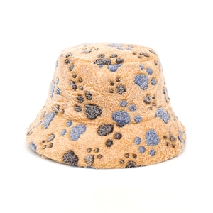 Beige plush bucket hat with dark paw print pattern made of soft faux lamb wool material