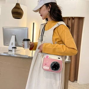Pink and white retro camera-shaped crossbody bag with 'Say cheese' print and PU leather