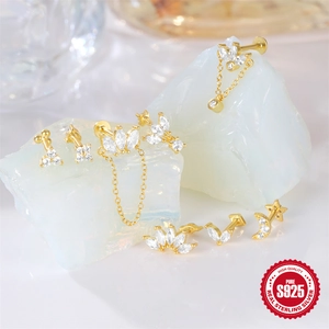 Elegant gold S925 sterling silver crown marquise earrings displayed on crystals