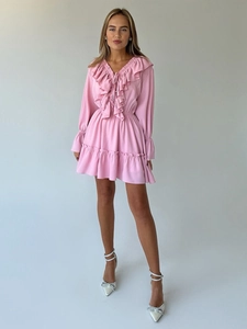 Detail of pink chiffon dress featuring a V-neckline with decorative layered ruffles